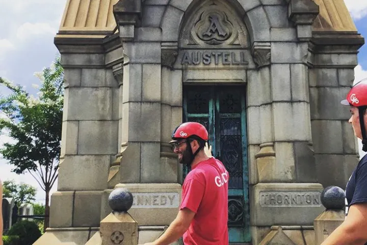 A guide giving the story behind a local monument.
