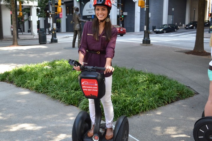 A woman smiling for the camera while on a segway tour