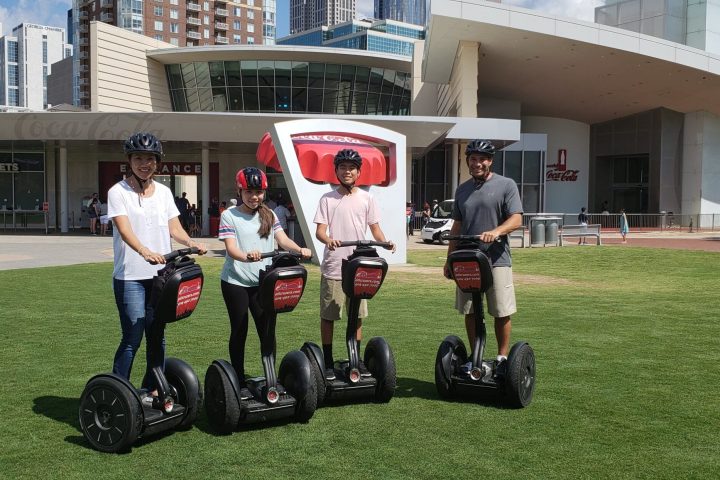 a group of people playing football in front of a building