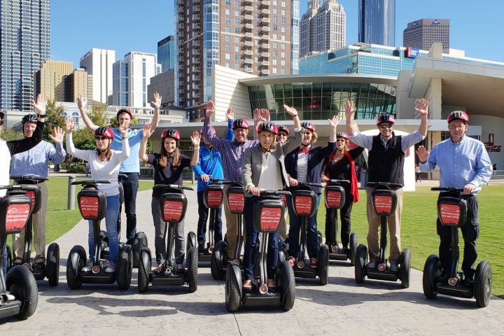 a group of people riding on the back of a motorcycle