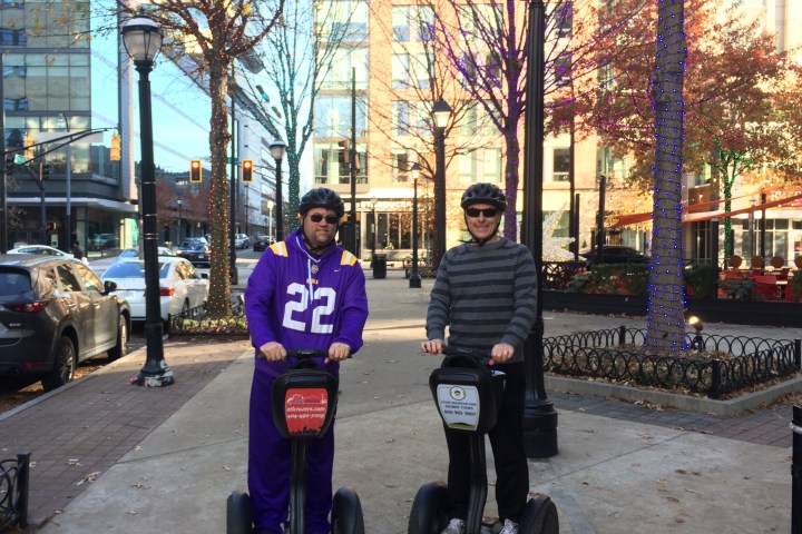 a person riding a skate board on a city street