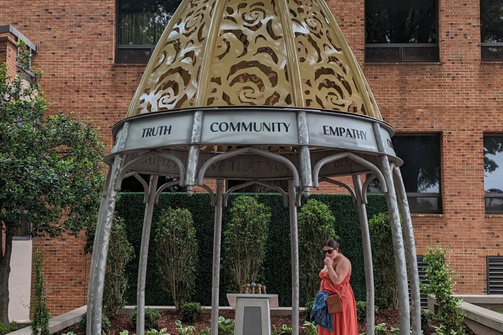 a statue in front of a brick building