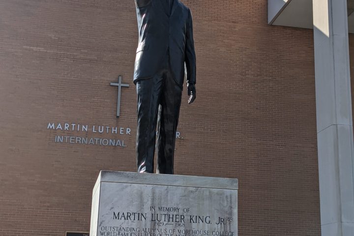 a statue of a man standing in front of a building