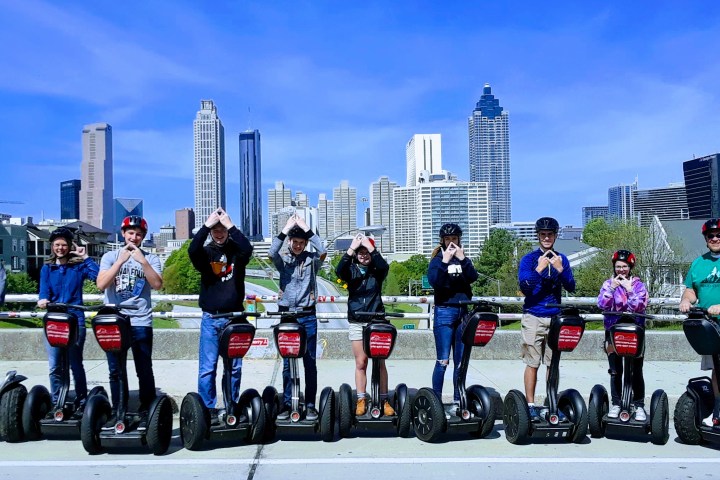 a group of people riding skis on a snowy road