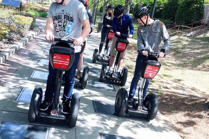 a group of people riding on the back of a motorcycle