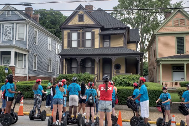 a group of people standing in front of a house