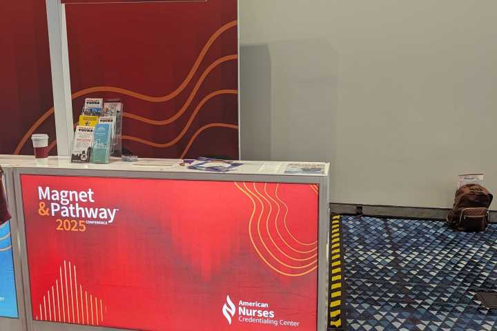 Conference booth with signage for Magnet & Pathway 2025 and Discover Atlanta.