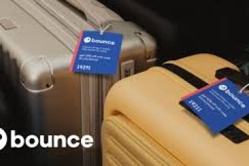 Two suitcases with Bounce tags, one silver and one beige, in a travel setting.